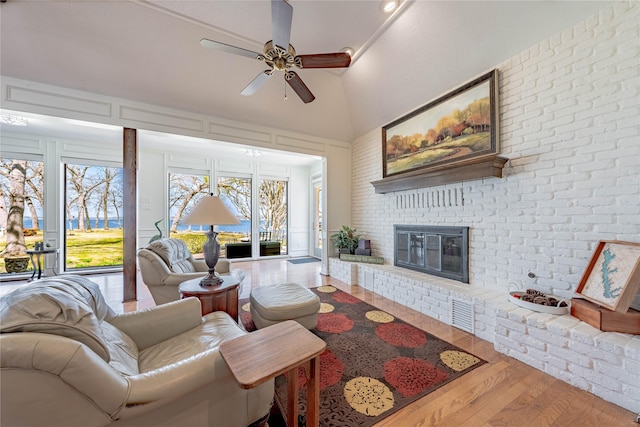 39 Lakeside Dr, Star Harbor, TX 75148 - living area featuring a ceiling fan, wood finished floors, a fireplace, and a towering ceiling