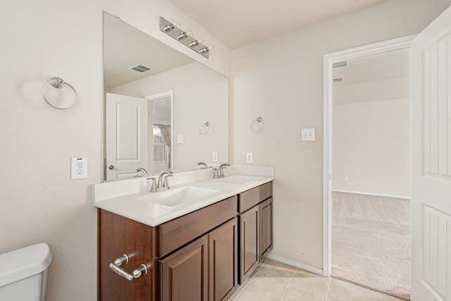 full bath featuring a sink, visible vents, toilet, and double vanity