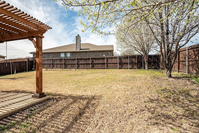 view of yard featuring a pergola and a fenced backyard