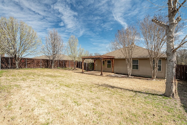 back of property with a pergola, a fenced backyard, a lawn, and a patio