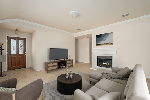 living room with visible vents, baseboards, crown molding, and a lit fireplace