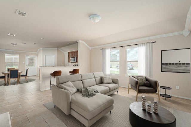 living room featuring crown molding, baseboards, and visible vents