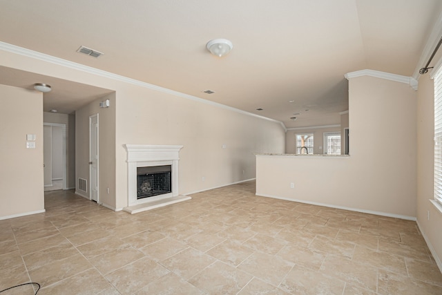 unfurnished living room featuring visible vents, a fireplace with raised hearth, and ornamental molding