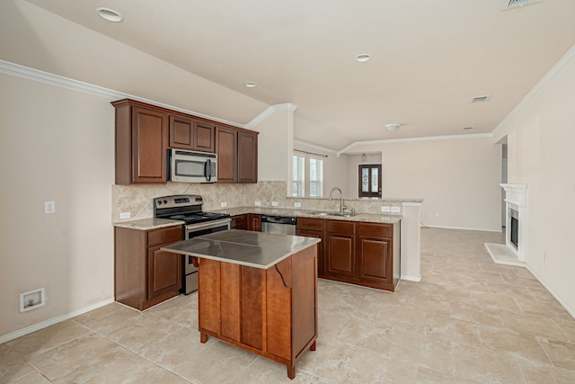 kitchen with a kitchen island, backsplash, appliances with stainless steel finishes, a peninsula, and crown molding