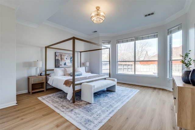 bedroom featuring visible vents, light wood-style flooring, and multiple windows