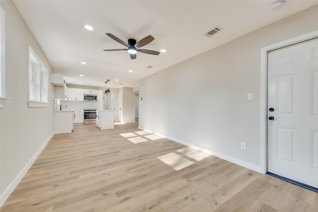 unfurnished living room featuring recessed lighting, visible vents, ceiling fan, and light wood-style flooring