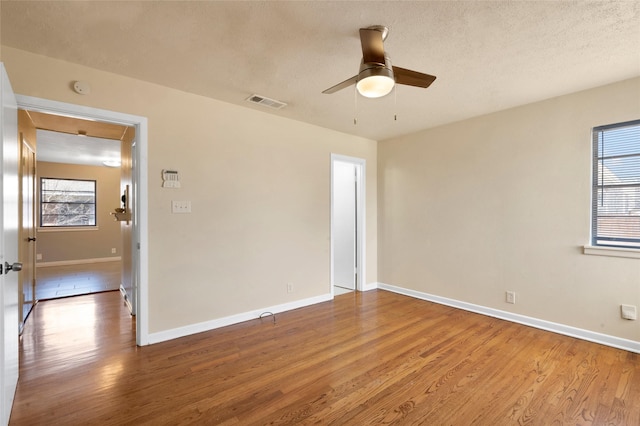4021 Kenley St, Fort Worth, TX 76107 - empty room with visible vents, a ceiling fan, a textured ceiling, wood finished floors, and baseboards