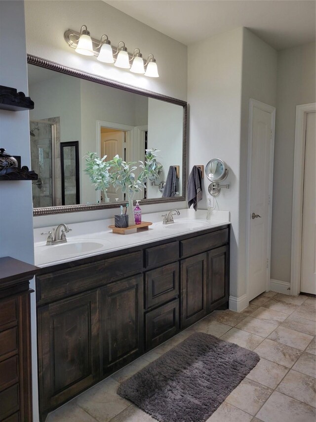 full bath featuring double vanity, a shower stall, and a sink