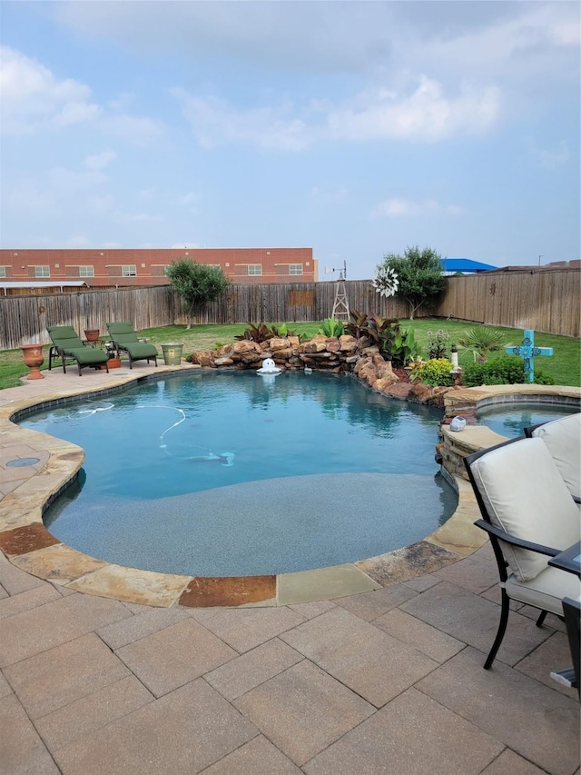 view of swimming pool featuring a patio area, a fenced backyard, a fenced in pool, and an in ground hot tub