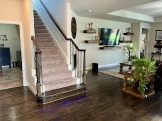 staircase with baseboards and wood finished floors