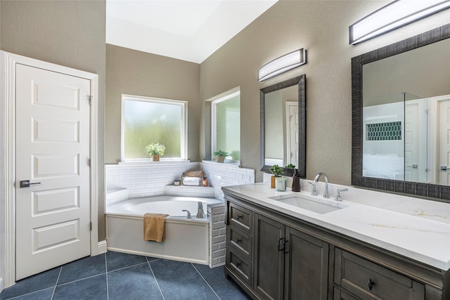 bathroom featuring a bath, tile patterned floors, vanity, and walk in shower