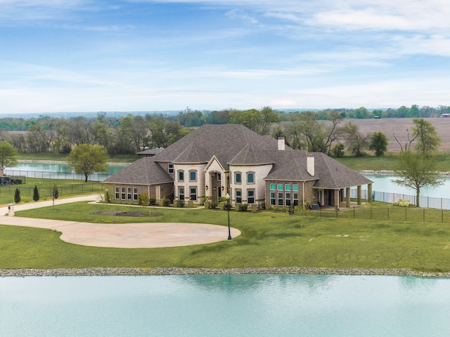 639 Calm Water Cv, Princeton, TX 75407 - exterior space featuring a water view, fence, a front lawn, and roof with shingles
