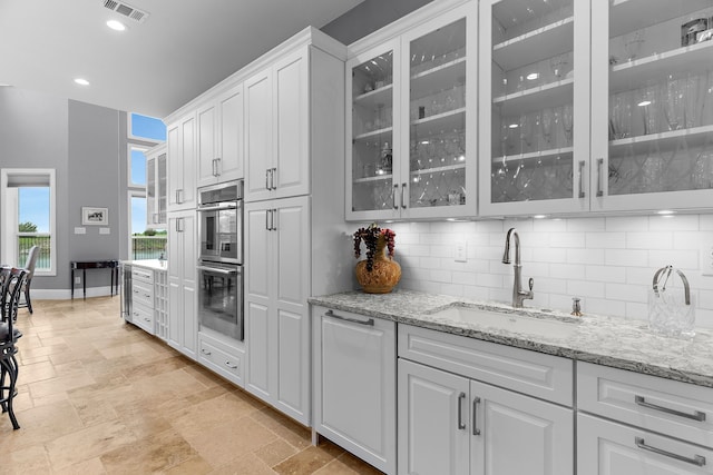 639 Calm Water Cv, Princeton, TX 75407 - kitchen featuring backsplash, a sink, stainless steel double oven, and visible vents