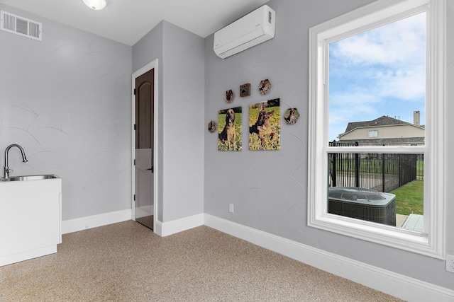 639 Calm Water Cv, Princeton, TX 75407 - spare room featuring visible vents, plenty of natural light, baseboards, a sink, and a wall unit AC