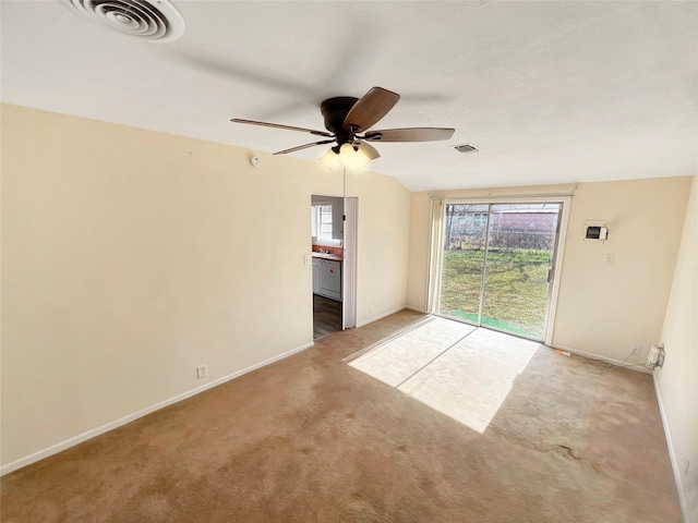 carpeted spare room with visible vents, a ceiling fan, baseboards, and a healthy amount of sunlight