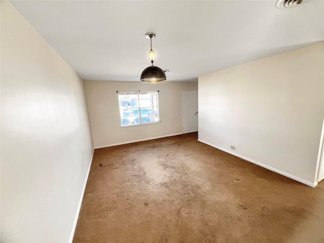 spare room featuring baseboards, carpet flooring, and visible vents