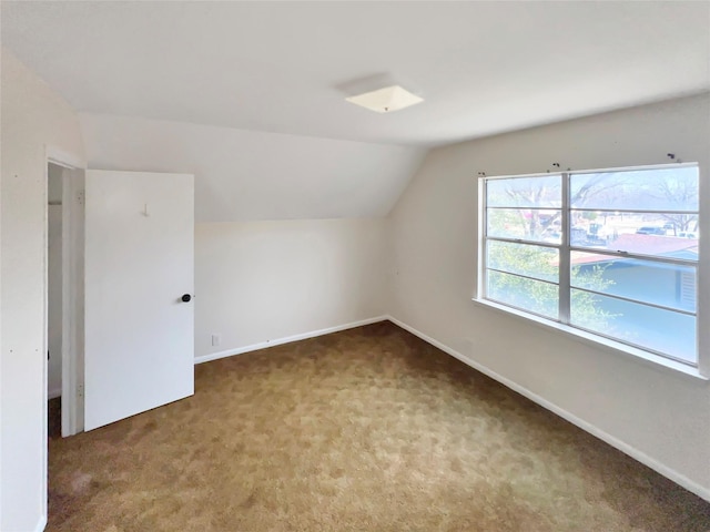 bonus room with vaulted ceiling, carpet flooring, and baseboards