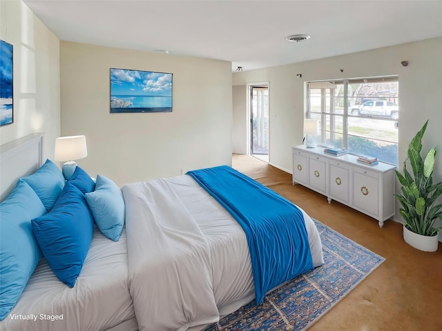 bedroom featuring visible vents and light colored carpet