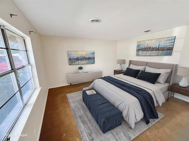 bedroom featuring visible vents, baseboards, and multiple windows