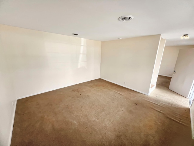 spare room with visible vents, carpet flooring, and baseboards