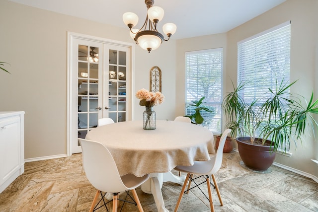 2710 Chalmers Ct, Rockwall, TX 75032 - dining room with baseboards and a chandelier
