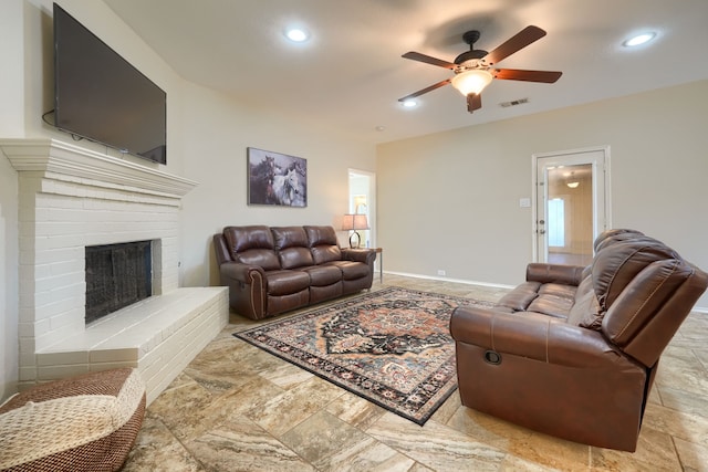 2710 Chalmers Ct, Rockwall, TX 75032 - living area featuring a ceiling fan, recessed lighting, a brick fireplace, stone finish floors, and baseboards