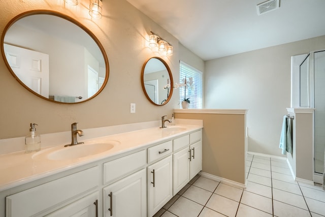 2710 Chalmers Ct, Rockwall, TX 75032 - full bath featuring tile patterned flooring, double vanity, baseboards, and a shower with door