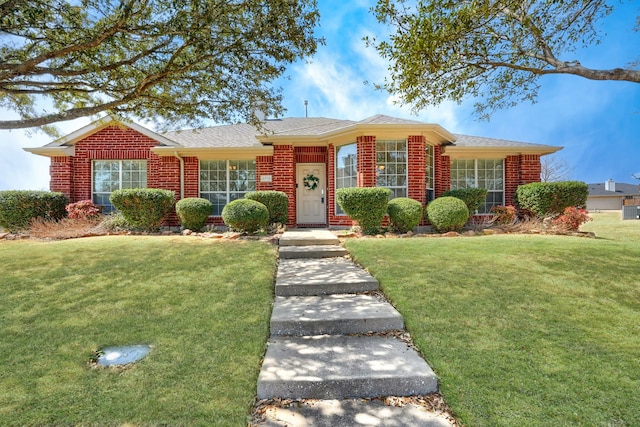 2710 Chalmers Ct, Rockwall, TX 75032 - view of front of home featuring brick siding, a front lawn, and a shingled roof