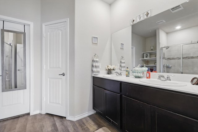 3013 Dominion St, Denton, TX 76209 - full bath with a stall shower, wood finished floors, double vanity, and baseboards