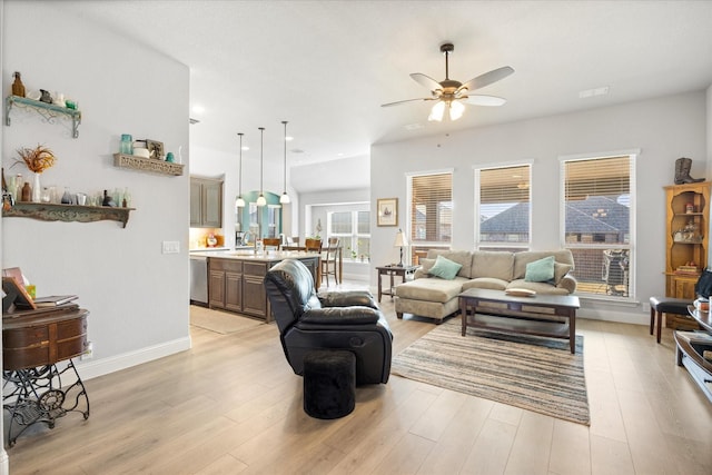 living room with visible vents, baseboards, recessed lighting, light wood-style flooring, and a ceiling fan