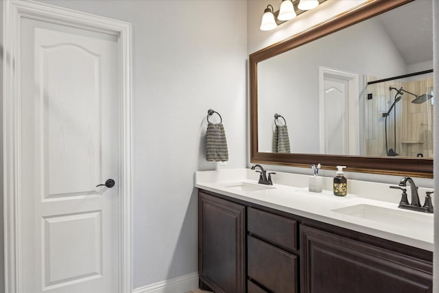 full bathroom with double vanity, an enclosed shower, vaulted ceiling, and a sink