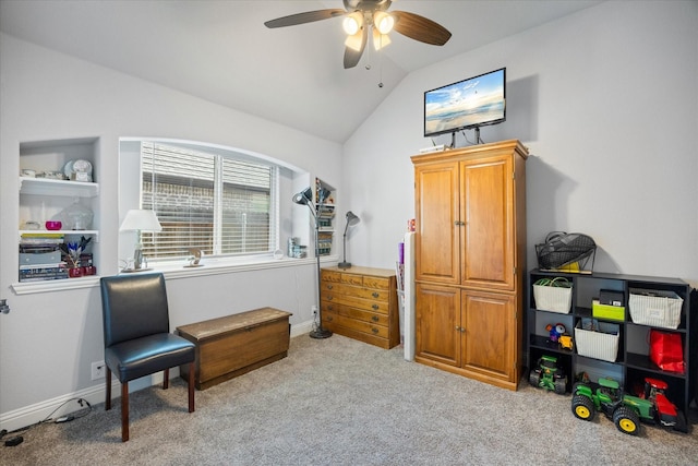 sitting room with vaulted ceiling, light colored carpet, baseboards, and ceiling fan