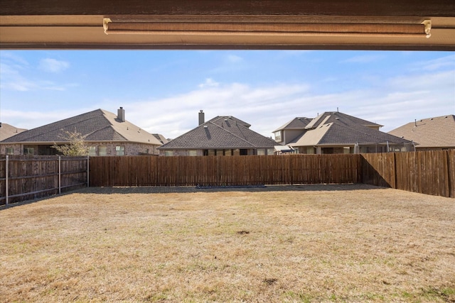 view of yard with a fenced backyard