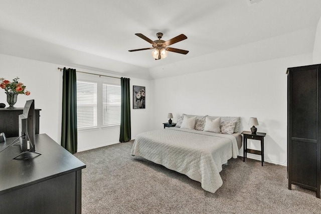 bedroom featuring lofted ceiling, a ceiling fan, baseboards, and light carpet