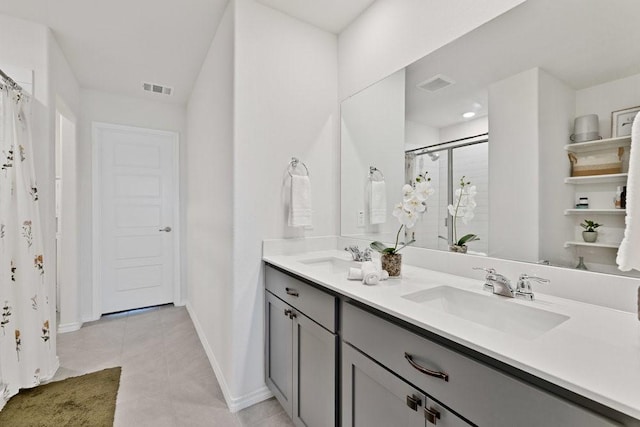 bathroom with a sink, visible vents, and a shower stall