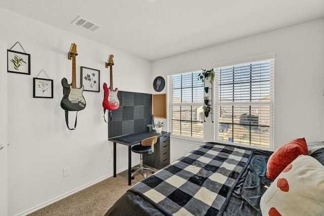 carpeted bedroom with visible vents and baseboards