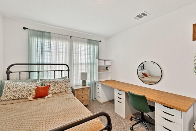 bedroom featuring visible vents and light colored carpet