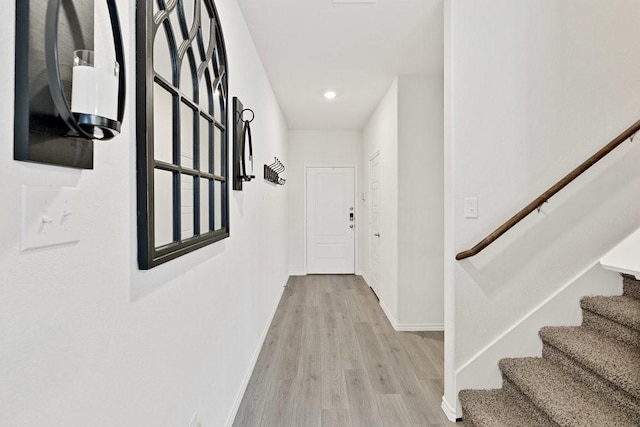 corridor featuring stairway, recessed lighting, light wood-style floors, and baseboards