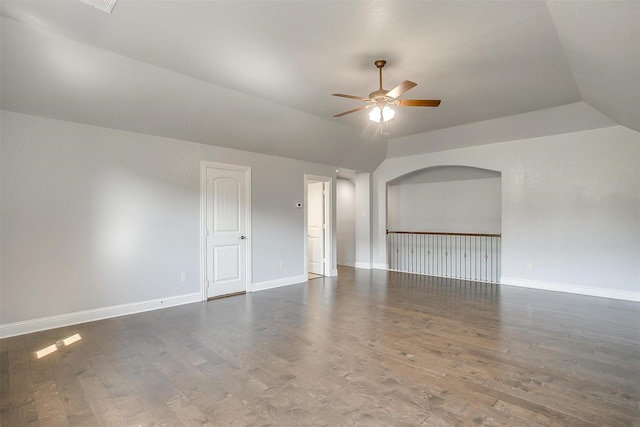 unfurnished room featuring baseboards, wood finished floors, ceiling fan, and vaulted ceiling