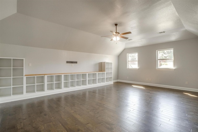 bonus room with baseboards, visible vents, dark wood finished floors, lofted ceiling, and ceiling fan