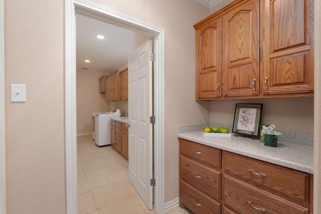 kitchen with light countertops, light tile patterned flooring, brown cabinetry, and baseboards