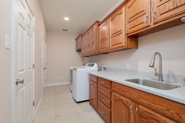 laundry room featuring visible vents, a sink, cabinet space, light tile patterned floors, and hookup for a washing machine