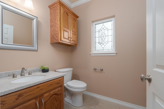 bathroom with tile patterned floors, toilet, ornamental molding, baseboards, and vanity