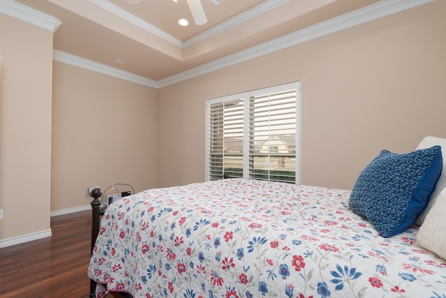 bedroom with wood finished floors, baseboards, recessed lighting, crown molding, and a raised ceiling