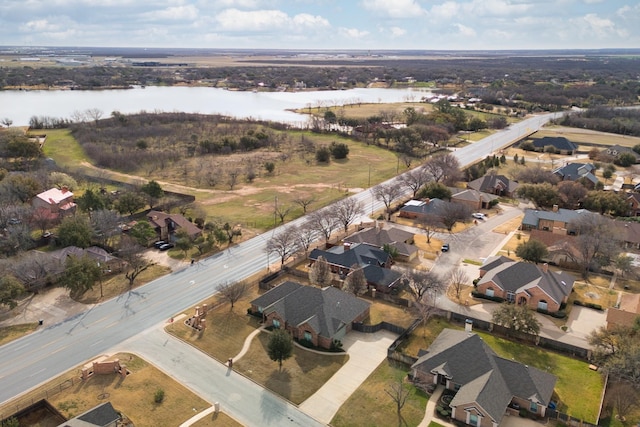 drone / aerial view with a residential view and a water view