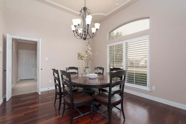 dining room with baseboards, high vaulted ceiling, an inviting chandelier, and dark wood-style floors