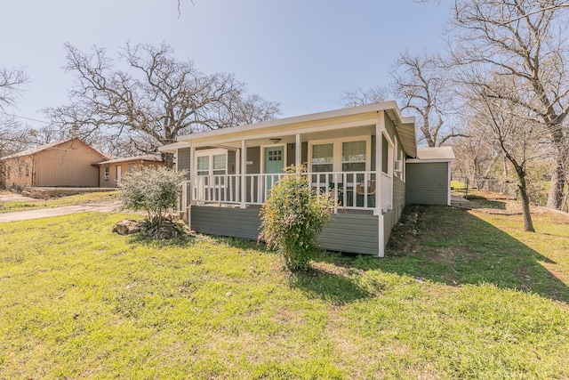 bungalow-style home with a porch and a front lawn