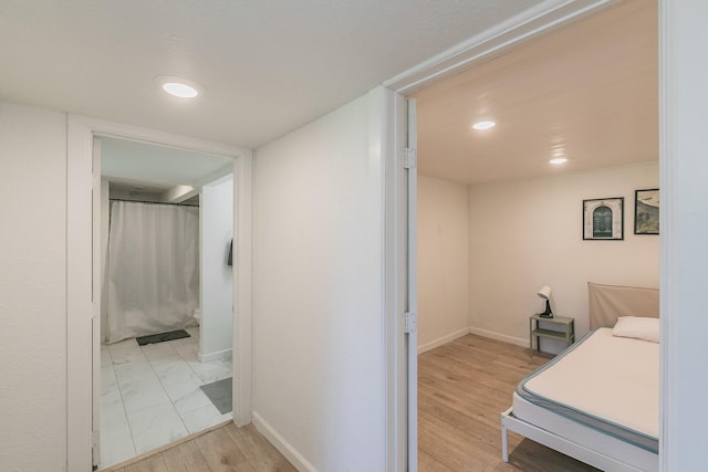 interior space featuring light wood finished floors, recessed lighting, and baseboards