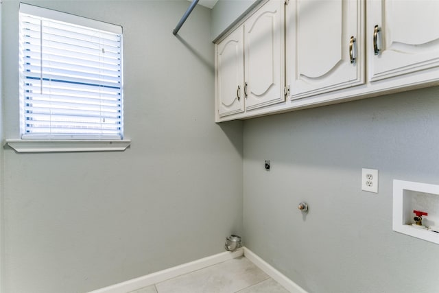 clothes washing area featuring baseboards, hookup for an electric dryer, light tile patterned flooring, cabinet space, and washer hookup