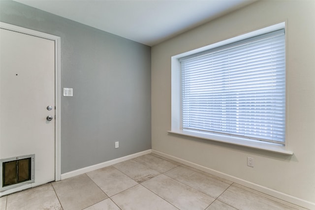 interior space featuring baseboards and tile patterned flooring